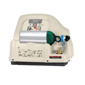 A Home Fill compressor in beige with a green and silver oxygen cylinder attached, featuring control knobs, gauges, and illustrated instructions on the front panel.